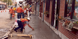 DPW workers rebuilding a sidewalk