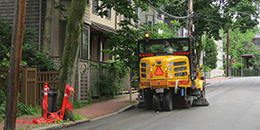 Photo of a street sweeper sweeping a street