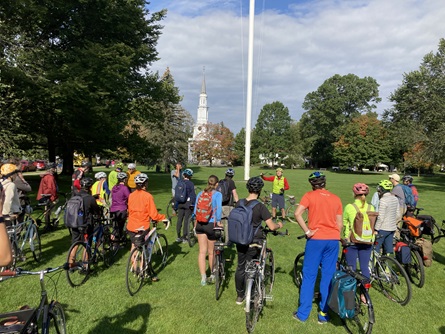 Urban Adventours staff give a historical talk to Cycle to the Source participants on Lexington Green.