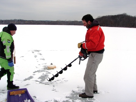CWD staff member prepares to drill a hole in the ice.