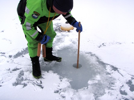 CFD staff measures the depth of the ice sheet. During this event, the ice depth ranged from 12-14 inches, with one fracture measuring 8 inches deep.