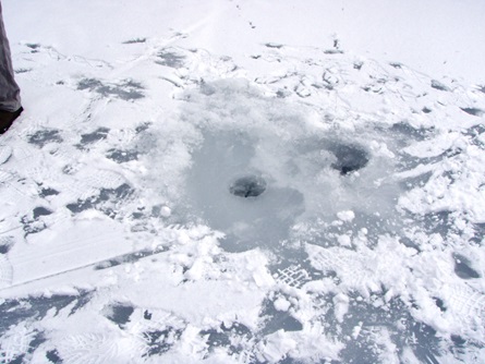 Holes drilled in the ice.
