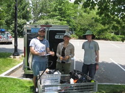 Fresh Pond Volunteers standing in front of volunteer storage trailer