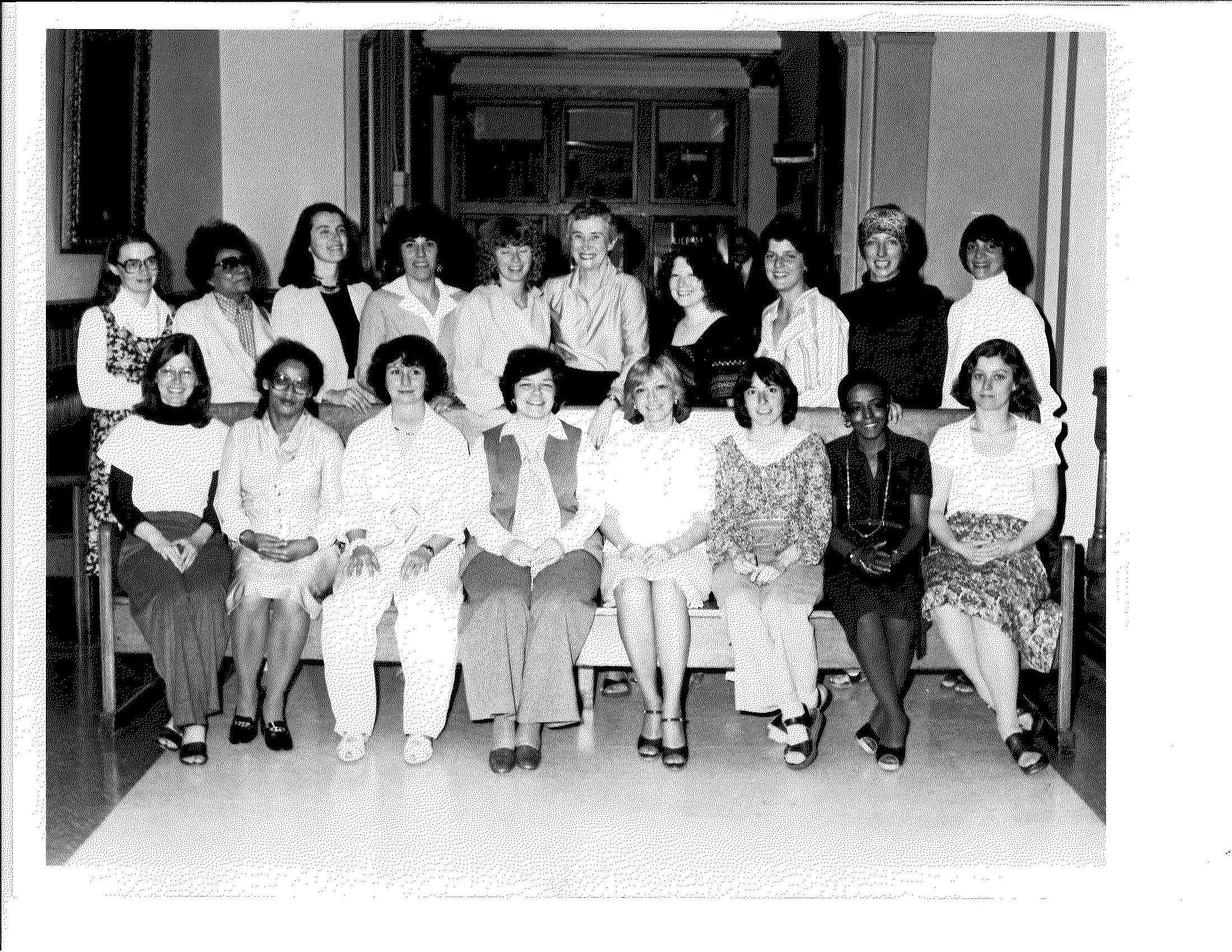 Photo of a group of women at the swearing in ceremony of the first Women's Commission in the late 1970s.