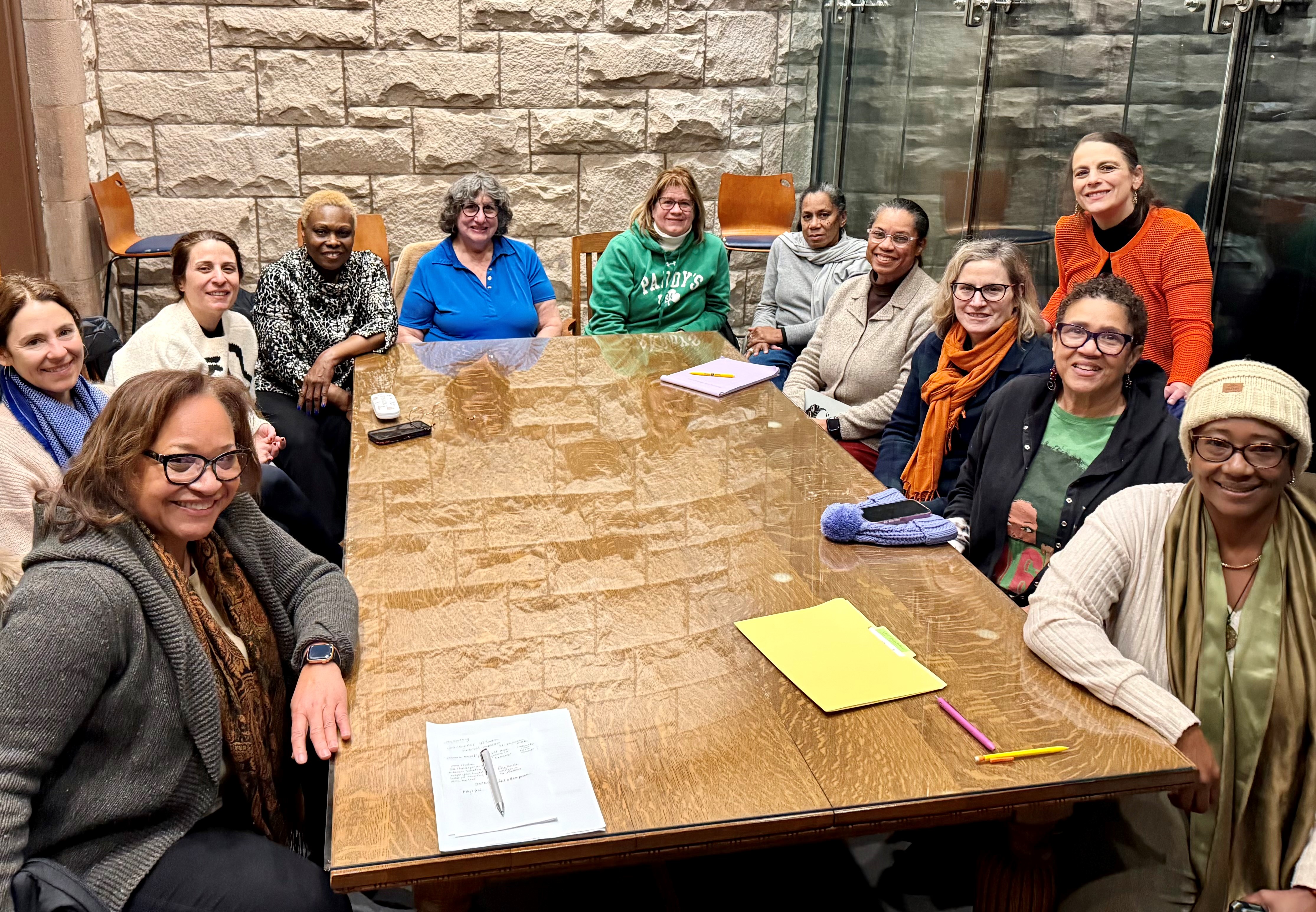 Photo of Women Gathered Around a Meeting Table