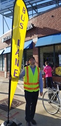 Image of MBTA staff holding a Bus Lane flag on PARKing Day 2018
