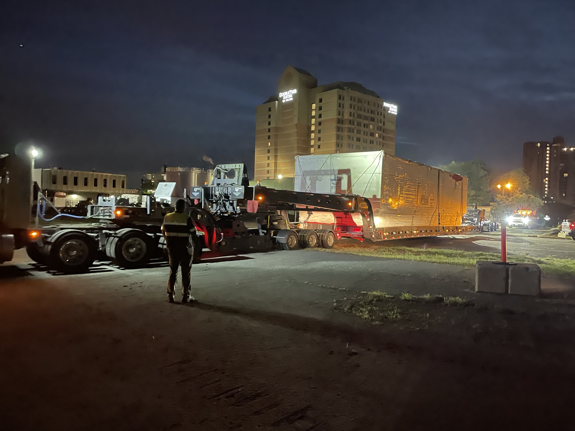A truck carrying part of a modular fire station arrives at the Harvard staging area.