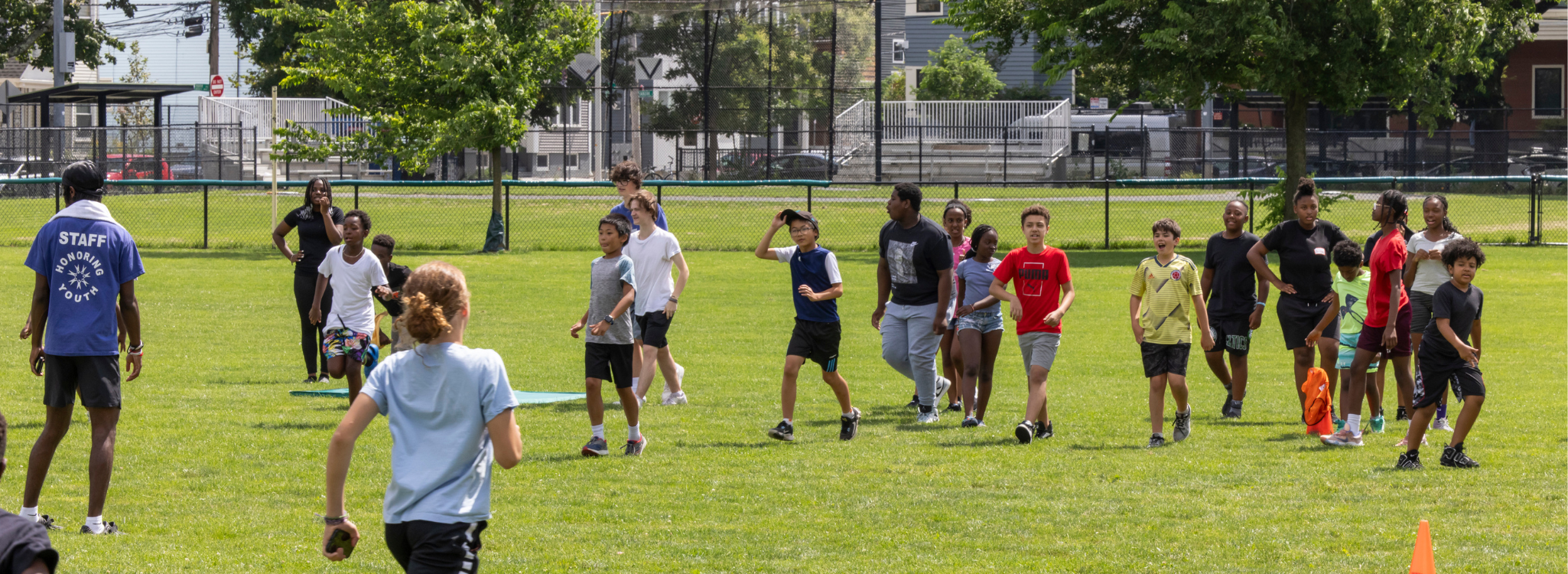 youth run on a field playing field day games