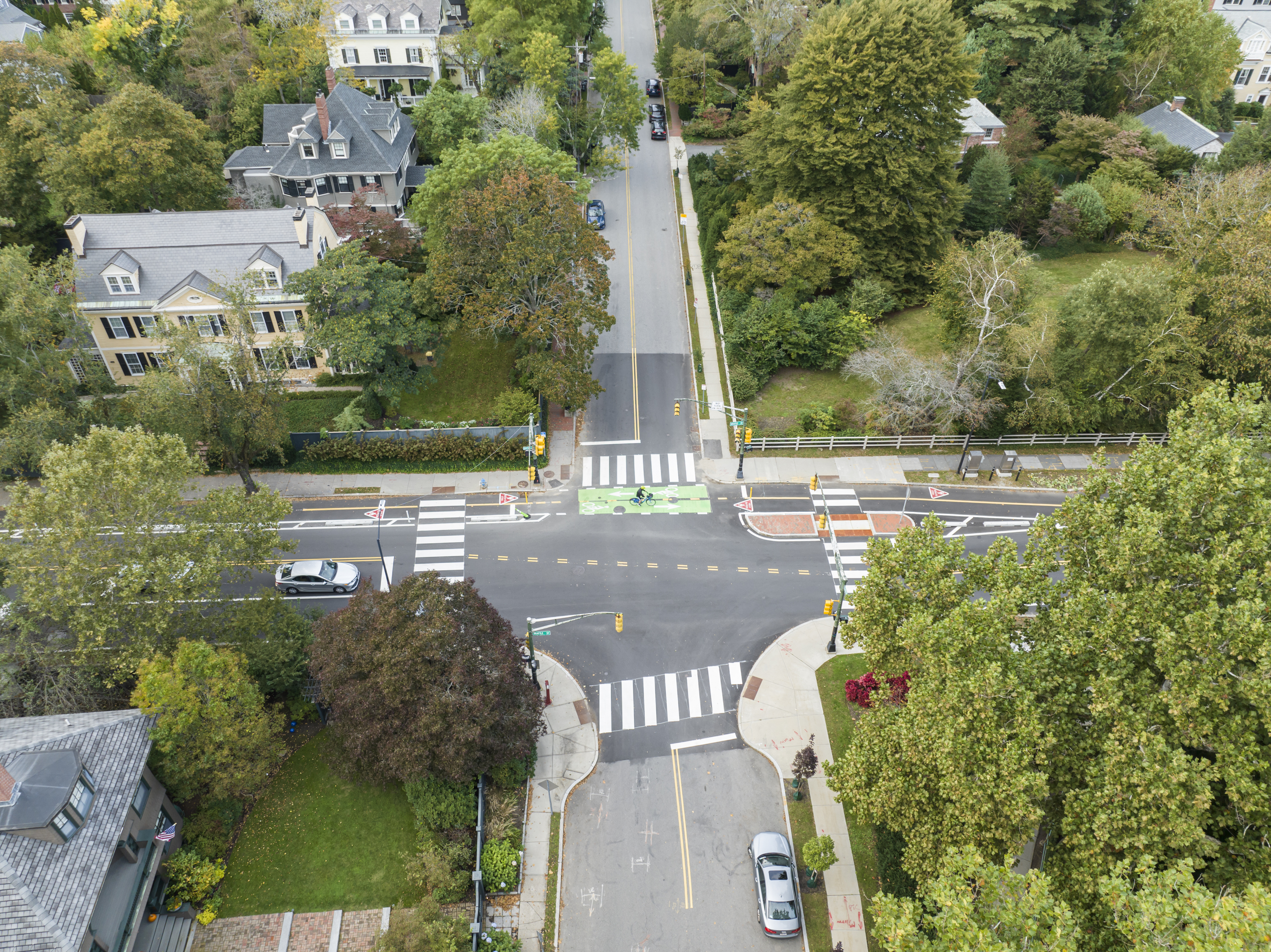 Aerial view of brattle street intersection and bike lanes. Person biking on separated bike lanes.