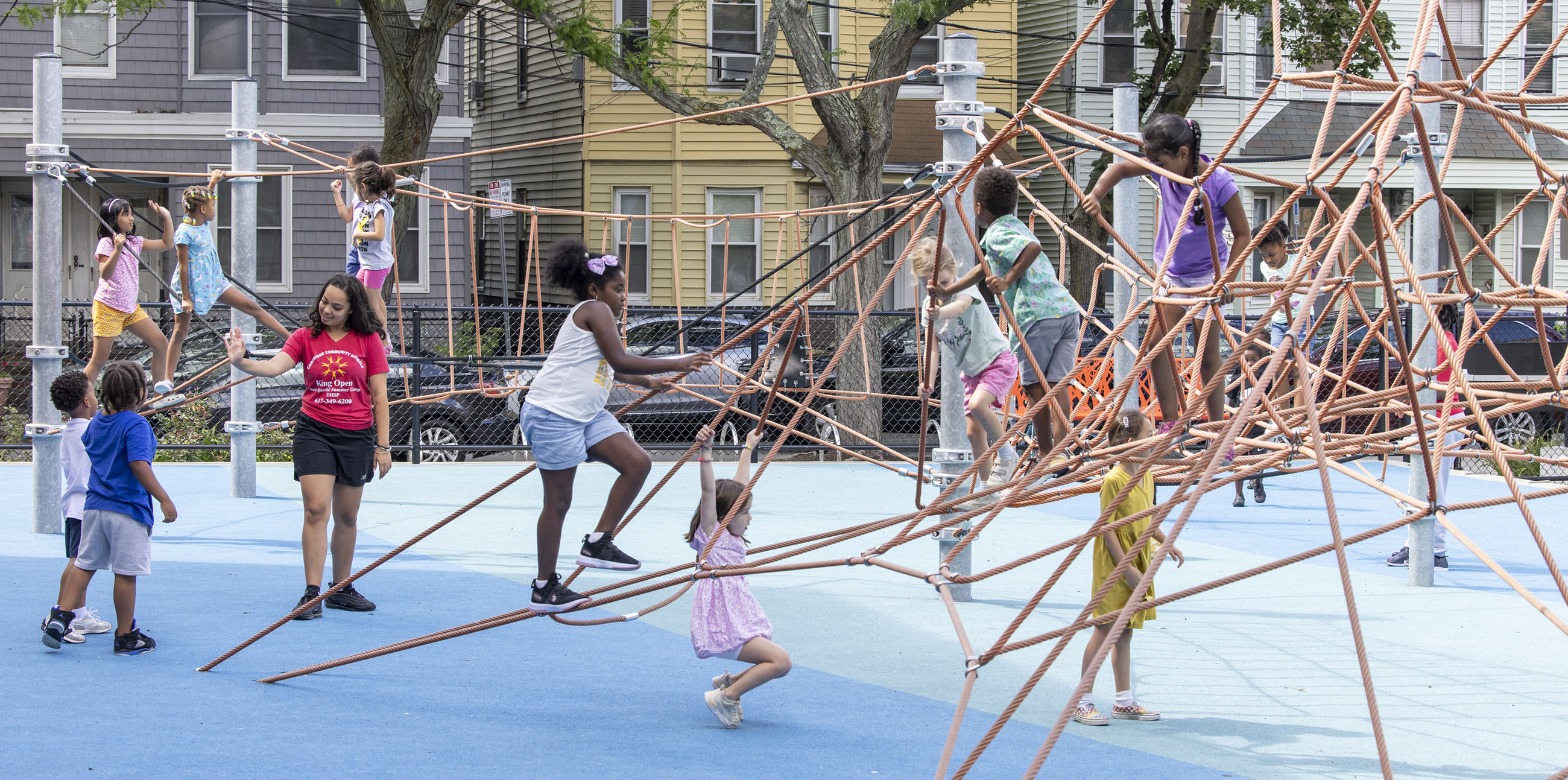 Summer Camp staff with children on a playground
