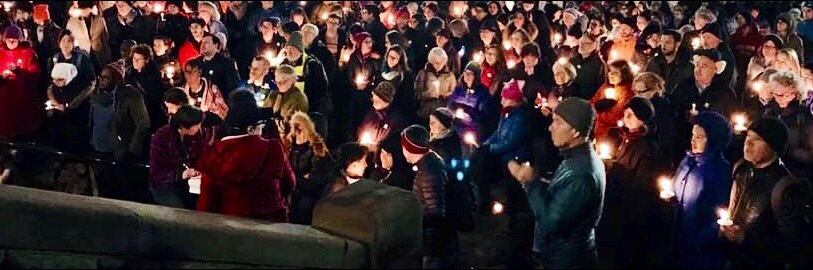 People gathered in front of Cambridge City Hall for a candlelight vigil
