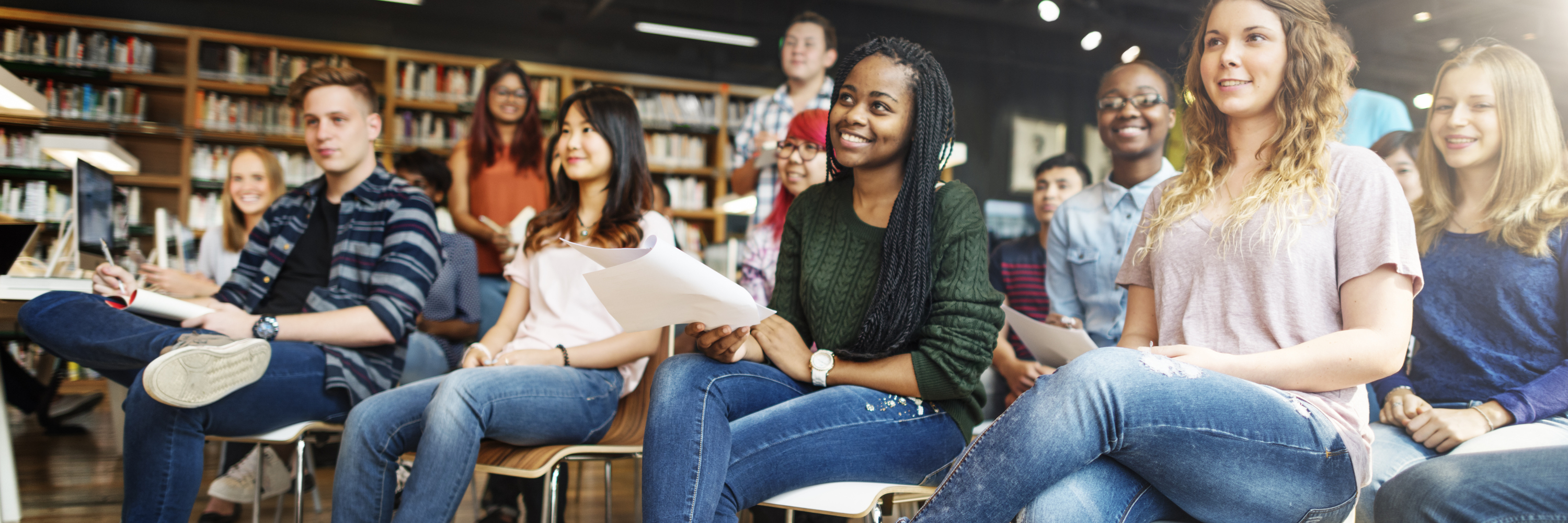 Photo of people sitting in chairs in a library