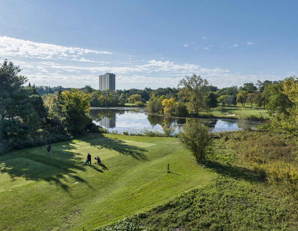 The Fresh Pond Golf Course with buildings in the distance.