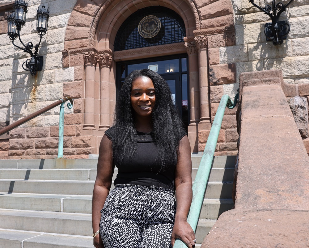 Deputy Budget Director Angela Alfred poses on the front steps of Cambridge City Hall