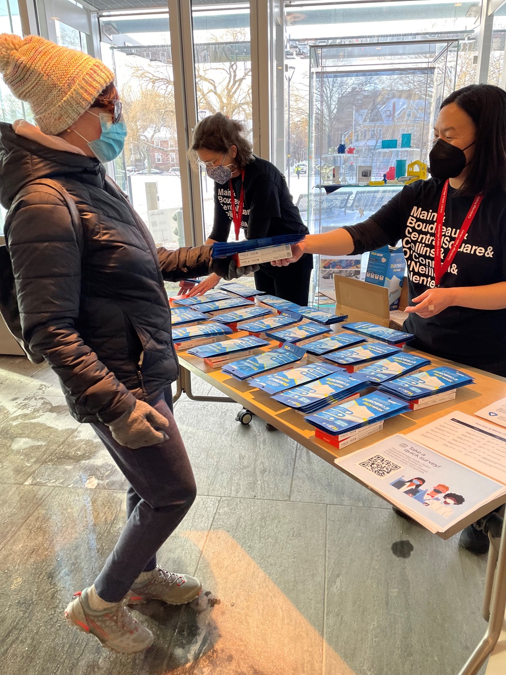 City staff hand out free at-home COVID-19 test kits.