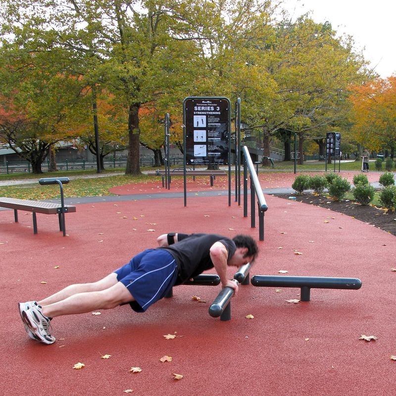 Man exercising on outdoor equipment