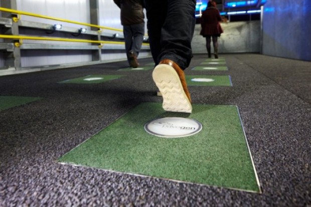 People walking over kinetic energy tiles