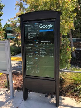A sign with information on the weather, the upcoming transit schedule, and nearby attractions.