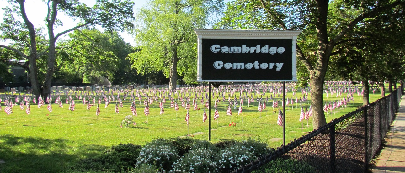 Cambridge Cemetery sign with american flags on each grave marker