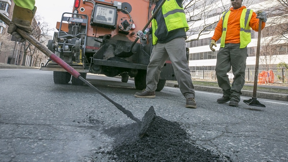 Crews filling a pothole